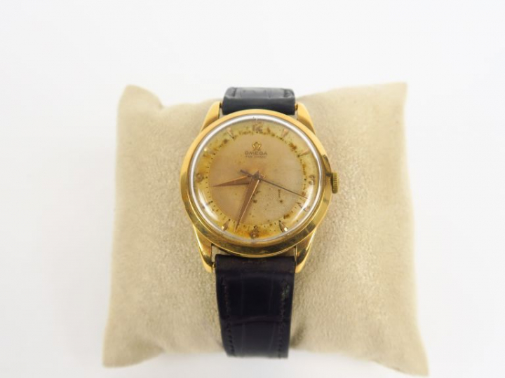 OMEGA.  Montre d'homme, boitier or, bracelet cuir.