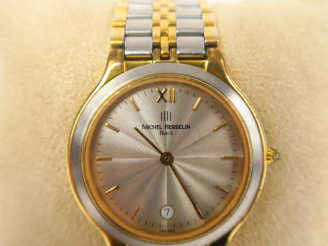 Vente aux enchères Michel HERBELIN  Montre de dame en métal et métal doré.