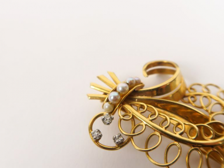 Broche en or jaune en forme de fleur ornée de cinq perles et de trois 