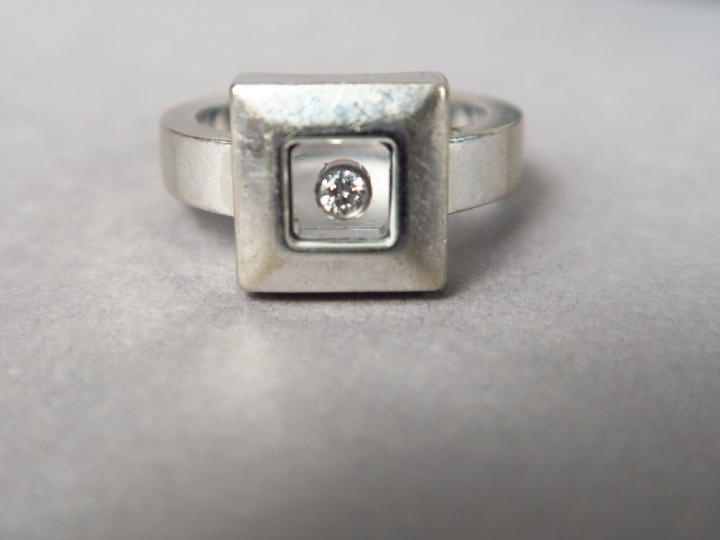 CHOPARD.  Bague en or blanc ornée d'un petit diamant. Signée.  TDD. 50