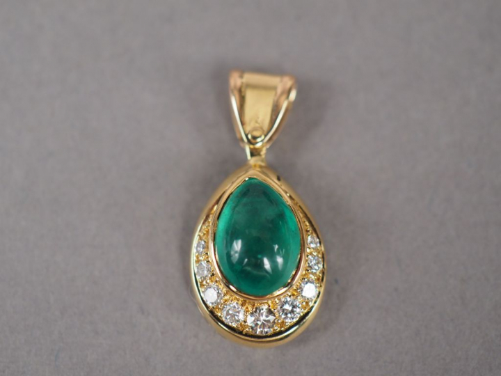 Pendentif en or jaune, orné d'une émeraude en cabochon et de neuf peti