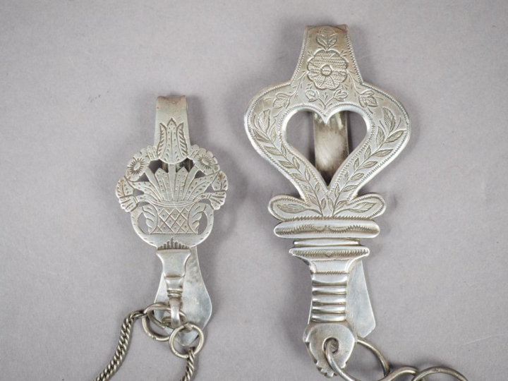 Deux différentes chatelaines en argent, poinçon Minerve.  Poids. 137 g