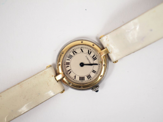 Vente aux enchères 	CARTIER. Montre de dame, modèle "Panthère" en or et acier.  Bracelet 