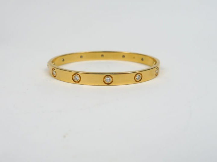 CARTIER.  Bracelet, modèle "Love" en or jaune et dix diamants.  Signé.