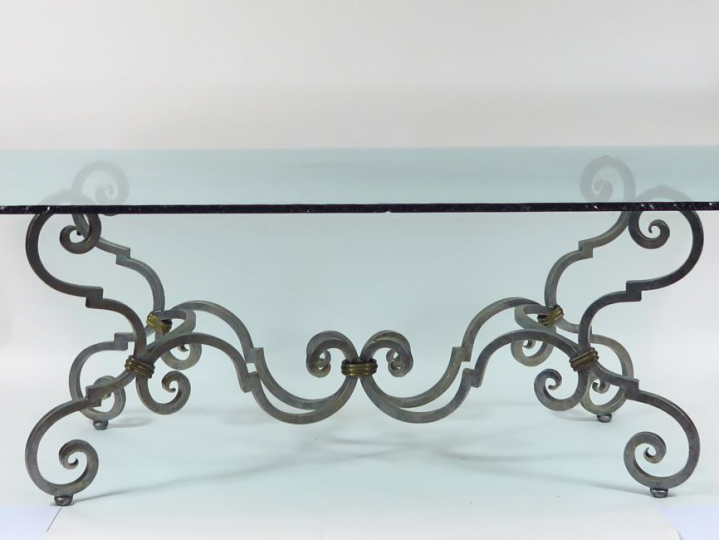 Table de salle à manger en verre et fer forgé à décor de consoles on y