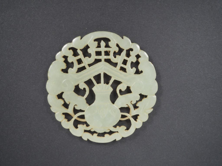 Lot comprenant : - un pendentif en jade céladon, à décor d'objets mobi