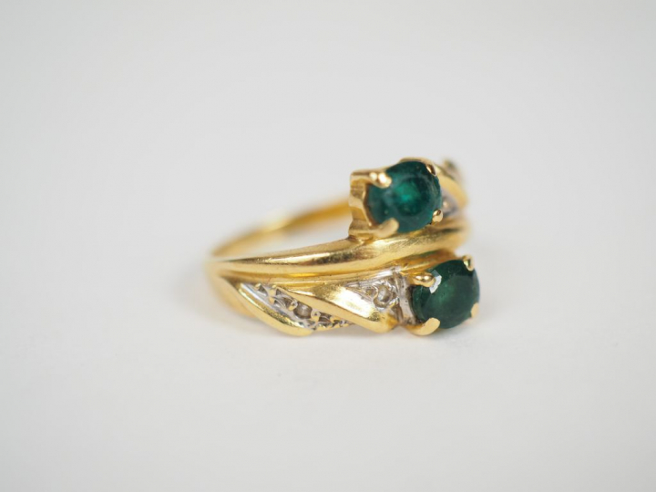 Bague "toi   moi" en or jaune, ornée de deux émeraudes et d'éclats de 