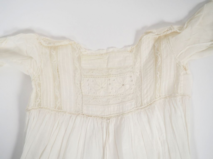 Réunion d'un robe de communiante d'une robe de baptême et d'un petit r