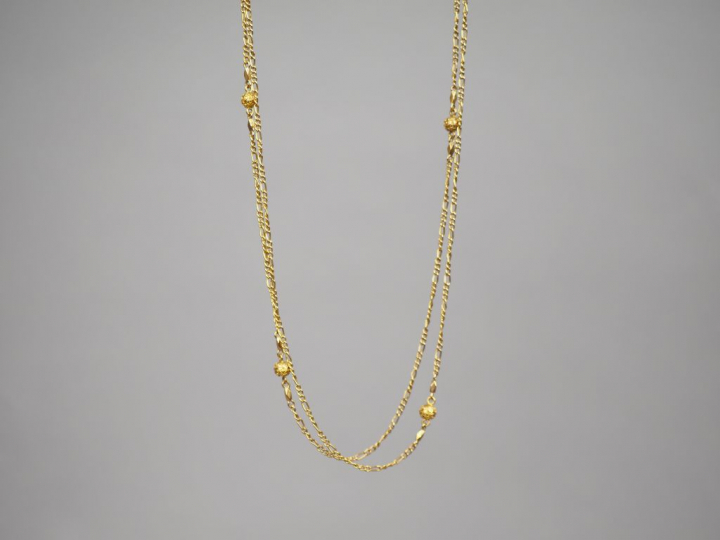 Collier double rangs en or jaune, à décor de boules filigranées. Poids