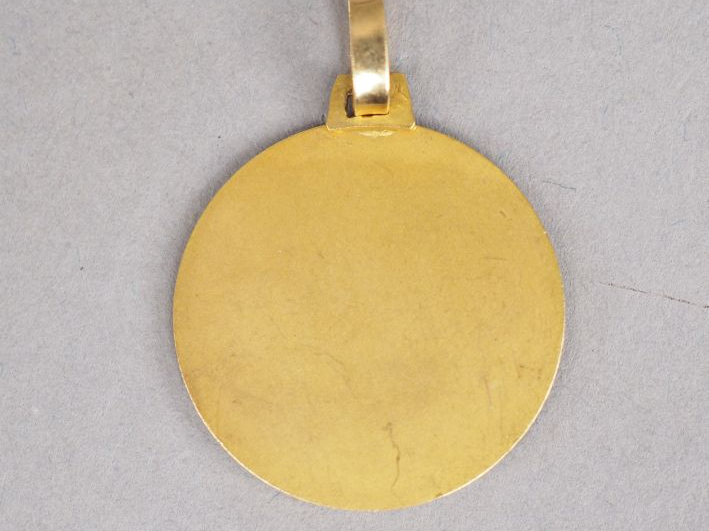 Médaille de baptême en or jaune figurant Saint Joseph et l'Enfant Jésu