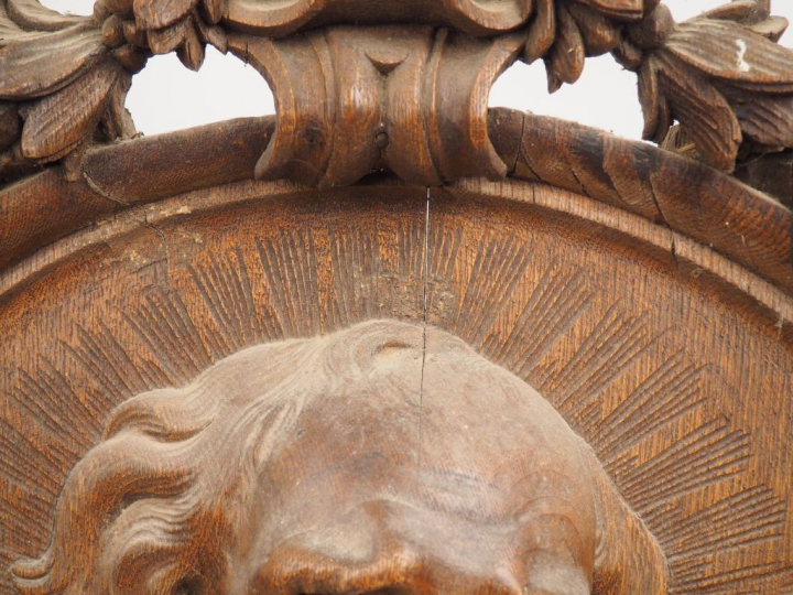 Grand médaillon en chêne sculpté en haut relief représentant un saint 