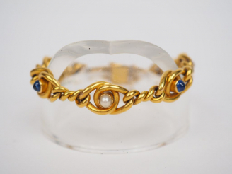 Vente aux enchères Bracelet souple en or jaune, à décor de perles et de pierres bleues en