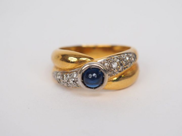 Bague en or jaune, ornée en son centre d'une pierre bleue en cabochon 