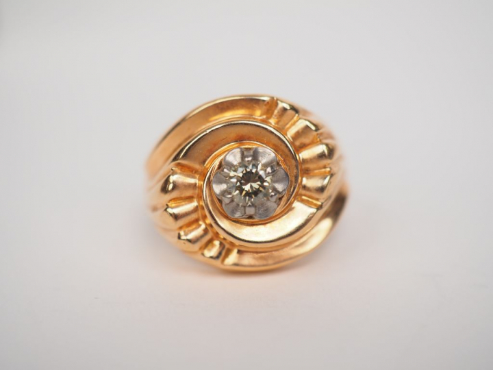 Bague en or jaune en forme de tourbillon, sertie en son centre d'un pe