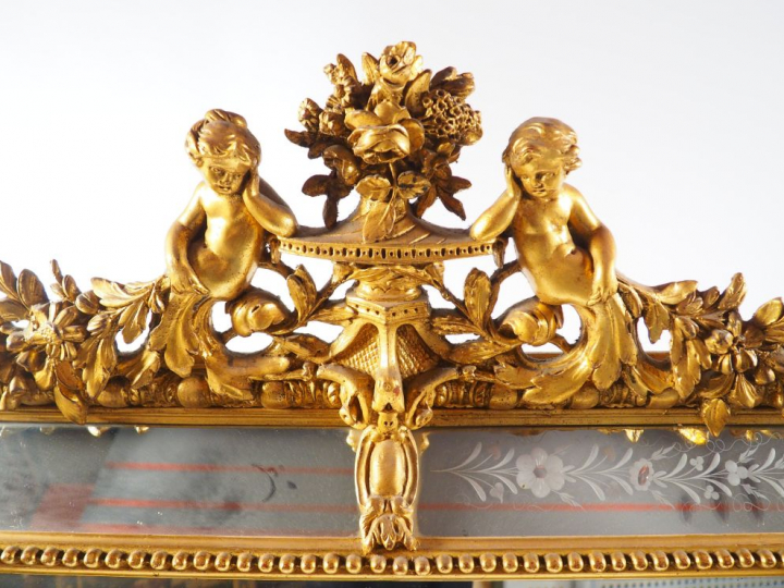 Grande glace à parecloses Napoléon III en bois et stuc doré, à décor d