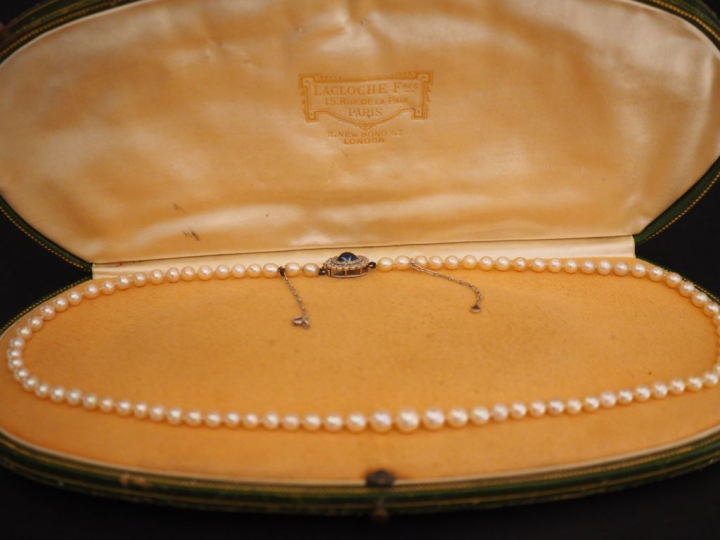 Collier de perles fines.  Fermoir en forme de marguerite ornée en son 
