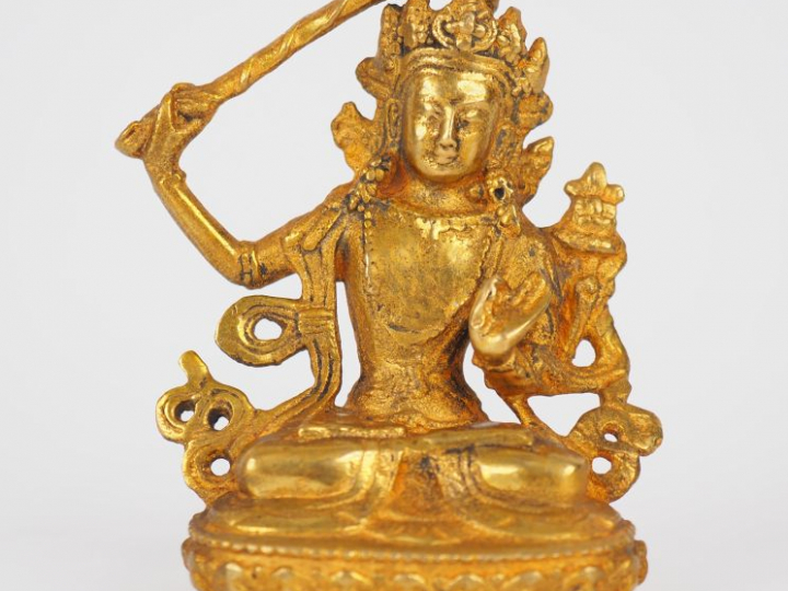 Tibet, XXe siècle,  Statuette en bronze doré représentant Manjusri ass