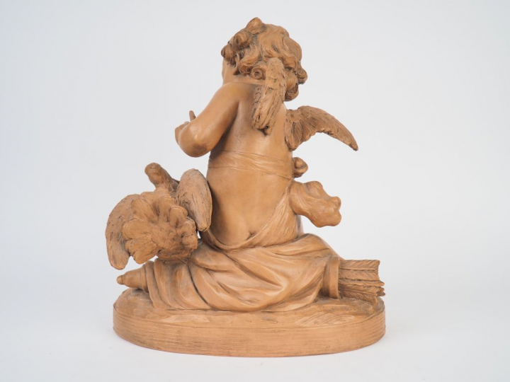 PIGALLE (d'après). "Amour à l'oiseau". Sculpture en terre cuite. Signé