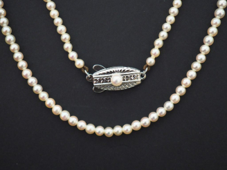 Vente aux enchères 	MIKIMOTO  Collier de perles de cultures. Fermoir en métal, à décor de