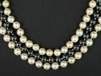 Vente aux enchères 	Collier ras de cou trois rangs de perles. Un rang de perles grises ép