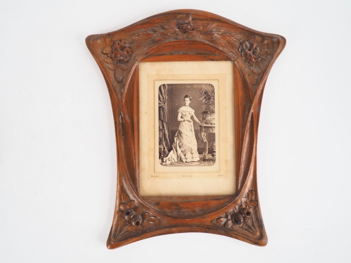 Cadre 1900 en bois naturel mouluré et sculpté à décor de fleurs. Dim. 