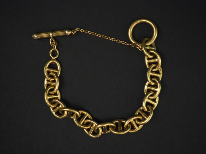 Bracelet articulé en or jaune, maille marine. Chainette de sécurité. L