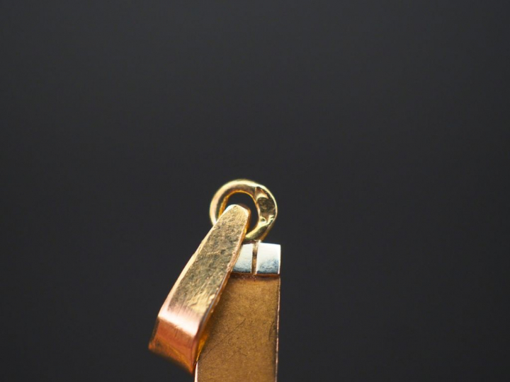Pendentif en forme de croix deux tons d’or. 2,8 x 1,9 cm Poids. 1,18 g