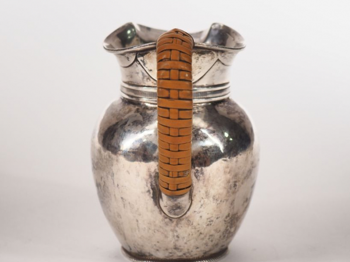 Pot à lait en argent, à décor d'une frise de godrons.  Anse gainée d'o