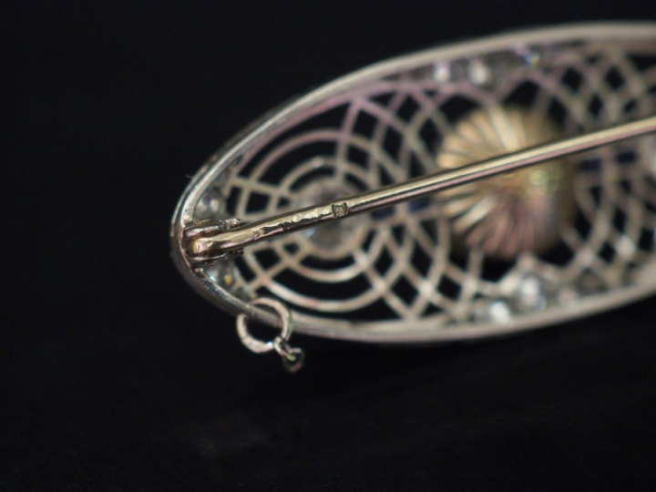 Broche ovale de style Art déco en or blanc, à décor ajouré et sertie d