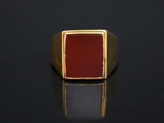 Vente aux enchères Bague de forme chevalière en or jaune, sertie en son centre d'une pier
