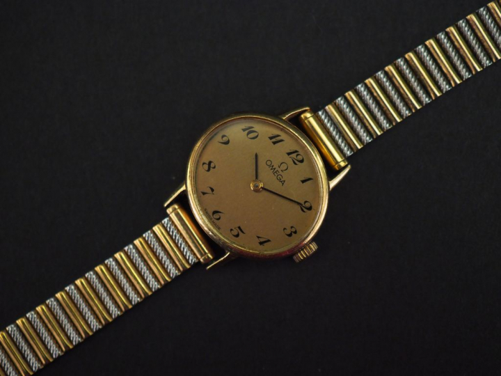 OMEGA Montre bracelet de dame, boitier en or jaune.  Cadran de forme o