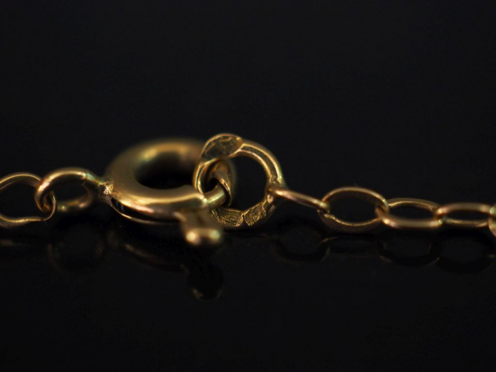 Bracelet souple en or jaune, perles blanches et pierres dures. Long. 1