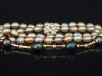Vente aux enchères Bracelet de perles grises de forme baroque et plaqué or. Fermoir en or