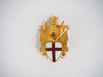 Vente aux enchères Insigne en bronze doré et émail (bélière de cravate de commandeur ?). 