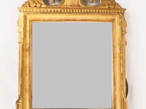 Miroir Napoléon III de style Empire en bois et stuc doré à décor d'une