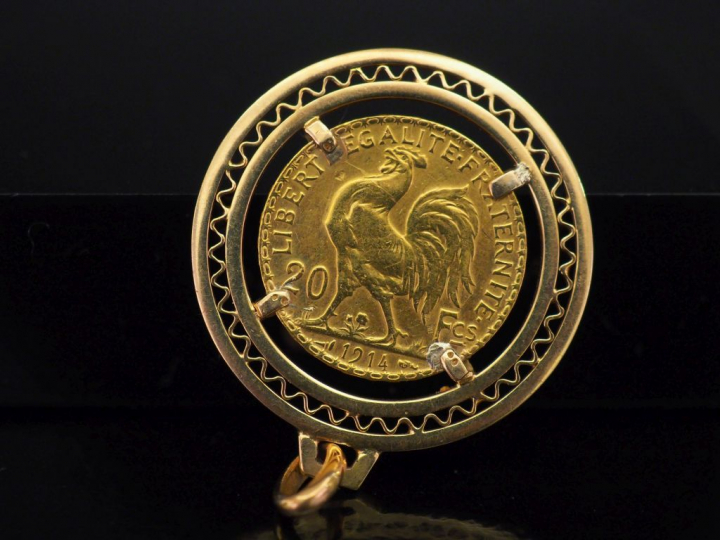 Pendentif en or jaune, à décor ajouré et serti en son centre d'une piè