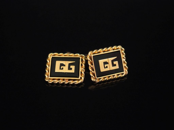 Paire de boutons de manchettes en or jaune et onyx noir, à décor de mo