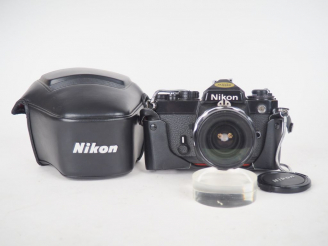 Vente aux enchères NIKON FE n°39711411. Appareil photographique avec sa housse et objecti