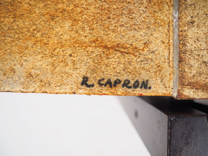 CAPRON.  Table basse, plateau en céramique à décor de feuilles, piétem