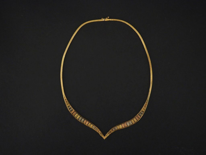 Collier articulé trois tons d'or, maille plate, se terminant en pointe