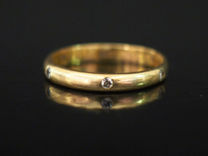 Alliance en or jaune, agrémentée de six petits diamants sertis clos. T