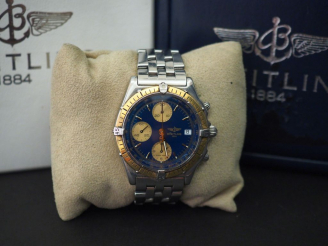 Vente aux enchères BRIETLING, Chronomat Montre chronographe en acier.  Cadran rond, lunet