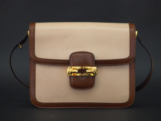 Vente aux enchères RICHARD, Paris Sac bandoulière en cuir crème et marron.  Finitions en 
