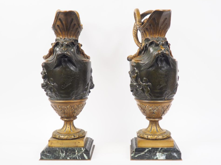 CLODION (d'après).  Paire d'aiguières en bronze patiné, à décor de mas