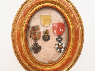 Vente aux enchères Cadre ovale en bois doré et verre bombé contenant une croix de guerre 
