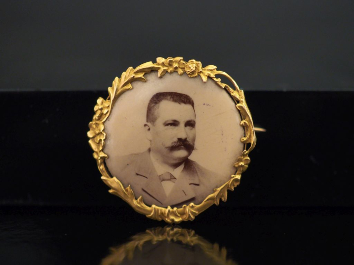 Petite broche ronde en or jaune 750, à décor de guirande de branchage 