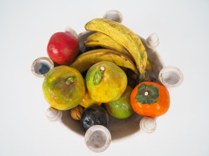 Vingt-et-un fruits en céramique et plâtre polychrome dans une coupe en