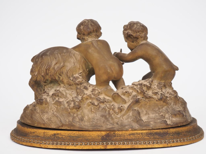 Groupe en terre cuite patinée "faunes jouant avec un bouc".  Dim. 23 x