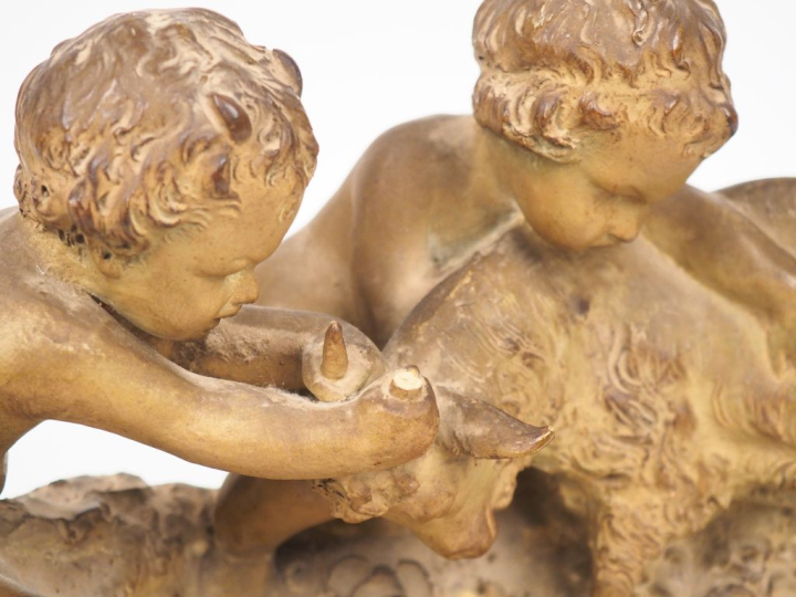 Groupe en terre cuite patinée "faunes jouant avec un bouc".  Dim. 23 x