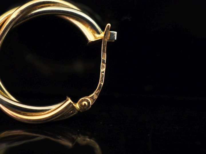 Ensemble comprenant :  - une créole torsadée trois tons d'or 750. Diam